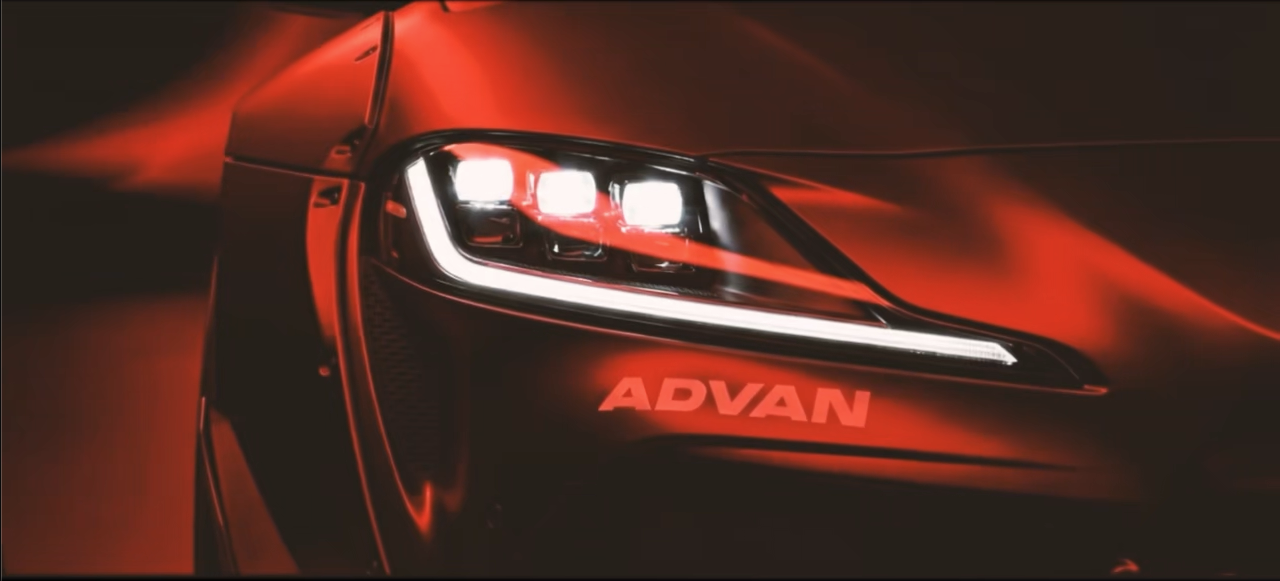Close-up of the red model car headlight and ADVAN mark