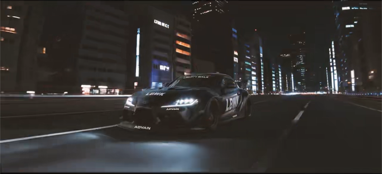 Low-angle model car moving through a city at night